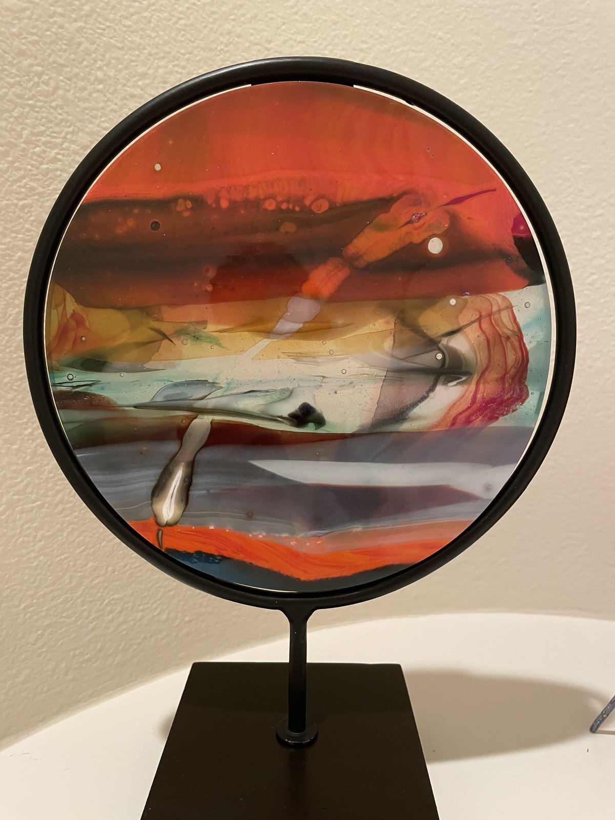 Fused glass art on display stand